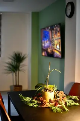 a table with a potted plant on top of it at Natura Apartments in Kranj