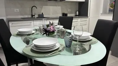 a dining room table with plates and glasses on it at Pri Drevoredu in Prvačina