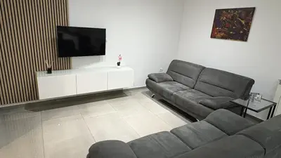a living room with a couch and a flat screen tv at Pri Drevoredu in Prvačina