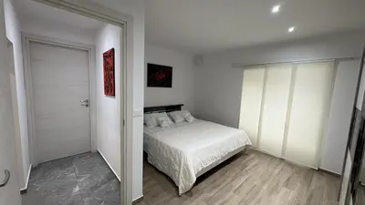 a bedroom with a bed and a sliding glass door at Pri Drevoredu in Prvačina