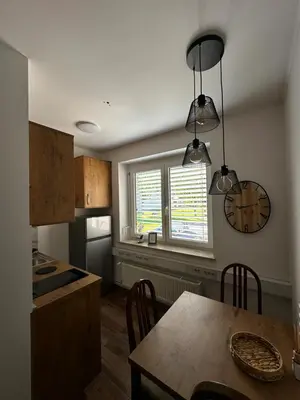 a kitchen with a table and a clock on the wall at Gostilna Menina in Gornji Grad