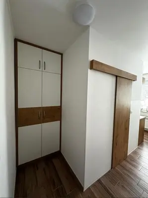 a room with white cabinets and a wooden door at Gostilna Menina in Gornji Grad