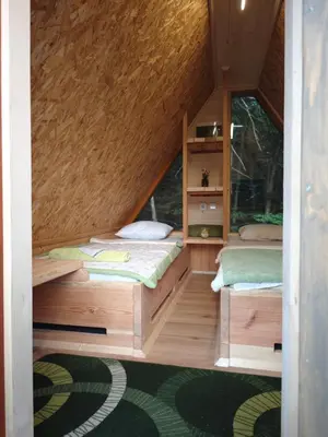 a room with two beds in a tiny house at AirWood Glamping in Križe