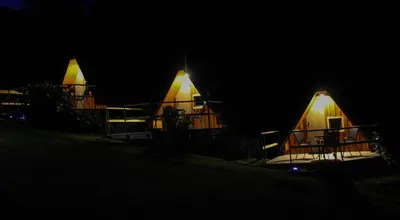 a house at night with its lights on at AirWood Glamping in Križe