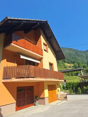 a building with a balcony on the side of it at Hiša pod Veliko planino in Stahovica