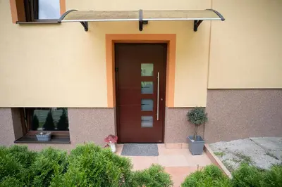 a front door of a house with a plant at Hiša pod Veliko planino in Stahovica
