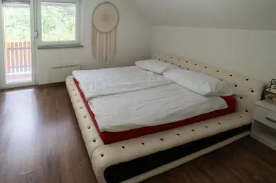a bed with a padded frame in a bedroom at Hiša pod Veliko planino in Stahovica