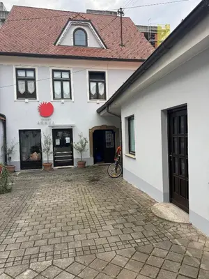 a white house with a brick driveway at My Star Apartment in Maribor