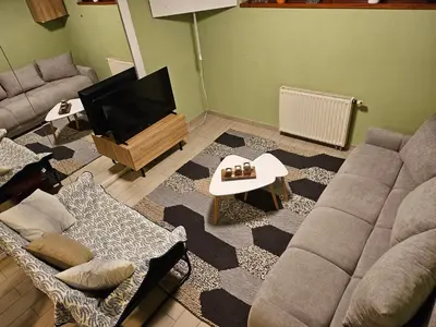 a living room with a couch and a flat screen tv at Radoslove Apt in Radovljica