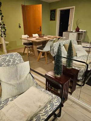 a living room with two beds and a table at Radoslove Apt in Radovljica