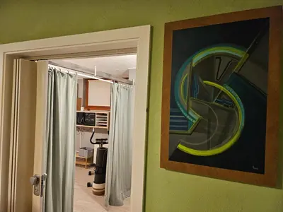 an open door to a room with a painting on the wall at Radoslove Apt in Radovljica