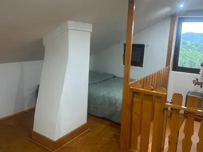 a bedroom with a bed and a window at DATA Bivalni vikend in Gruškovec