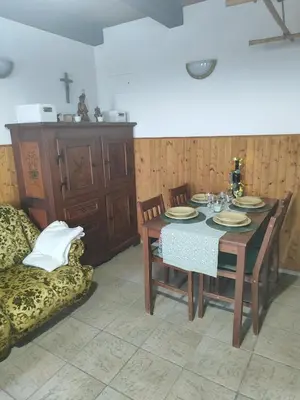 a dining room with a table and chairs and a couch at DATA Bivalni vikend in Gruškovec