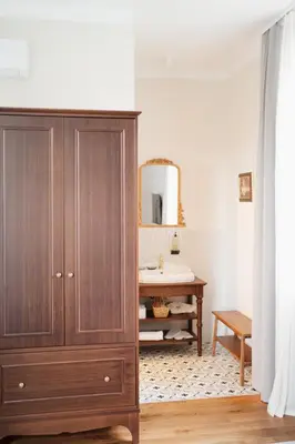a bathroom with a wooden cabinet and a sink at Stara šola Kaval in Novo Mesto