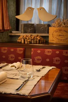 a table with a wine glass on top of it at Stara šola Kaval in Novo Mesto