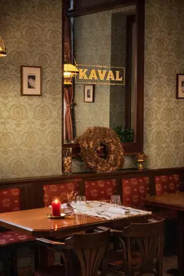 a dining room with a table and a mirror at Stara šola Kaval in Novo Mesto