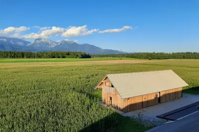 a barn in the middle of a field at The Barn Košnik in Kranj