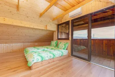 a sauna with a bed in a wooden cabin at The Barn Košnik in Kranj