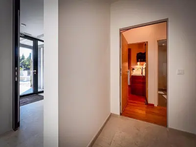 a hallway with a door leading to a kitchen at Studio Lumee in Ljubljana