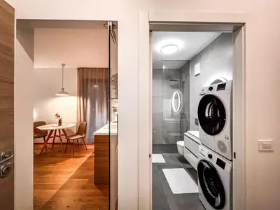 a kitchen with a washer and dryer in a room at Studio Lumee in Ljubljana
