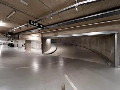 an empty parking garage with a sign in the middle at Studio Lumee in Ljubljana