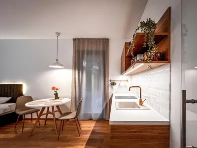 a small kitchen with a sink and a table at Studio Lumee in Ljubljana