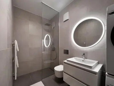 a bathroom with a sink and a toilet and a mirror at Studio Lumee in Ljubljana