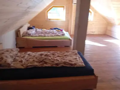 two beds in a room with a attic at Hiša Šujica in Ljubljana