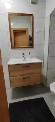 a bathroom with a sink and a mirror at Mala hiša in Solčava