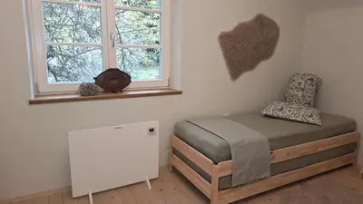 a bedroom with a bed and a window at Forest House Henriette in Ig