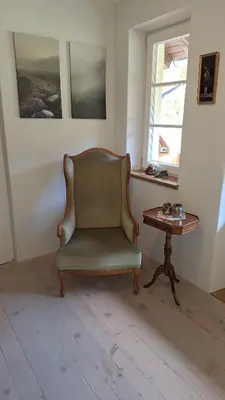 a living room with a chair and a table at Forest House Henriette in Ig