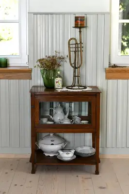 a wooden shelf with dishes and a trophy on top at Forest House Henriette in Ig
