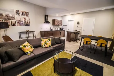 a living room with a couch and a table at Cankar's Private Place The Luxe in Ljubljana