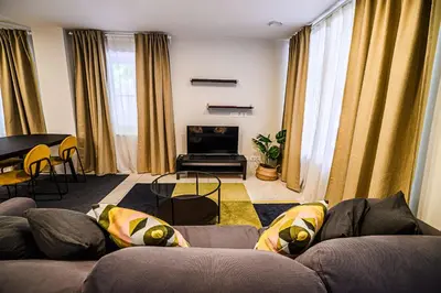 a living room with two couches and a piano at Cankar's Private Place The Luxe in Ljubljana