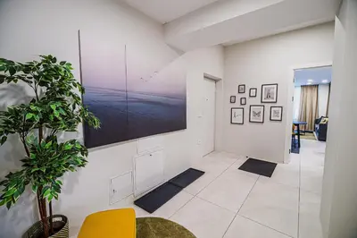 a living room with a large screen on the wall at Cankar's Private Place The Luxe in Ljubljana