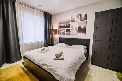 a bedroom with a bed with towels on it at Cankar's Private Place The Luxe in Ljubljana