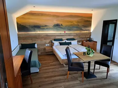 a bedroom with a bed and a table and chairs at Romantisches Kellerstöckl - Jeruzalem in Ivanjkovci