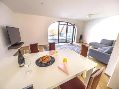 a living room with a table with a plate of food at By the river Ljubljana apartment in Rove