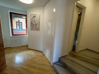a hallway of an art museum with a painting on the wall at By the river Ljubljana apartment in Rove