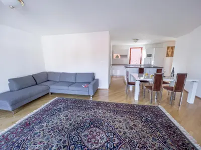 a living room with a couch and a table at By the river Ljubljana apartment in Rove