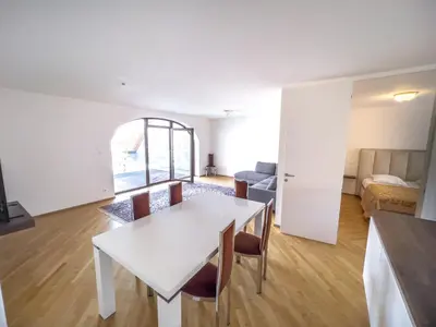 a living room with a white table and chairs at By the river Ljubljana apartment in Rove