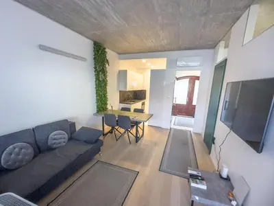 a living room with a couch and a table at Eiprova by the river in Ljubljana