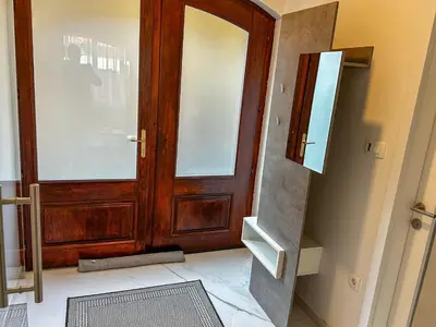 a wooden door in a room with a window at Eiprova by the river in Ljubljana