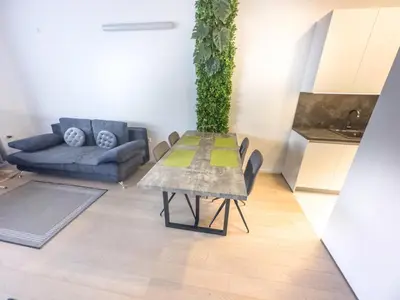 a living room with a table with a plant on it at Eiprova by the river in Ljubljana