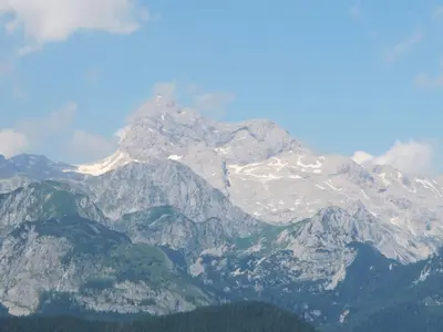 a mountain with snow on top of it at Apartment Zalokar in Bohinj