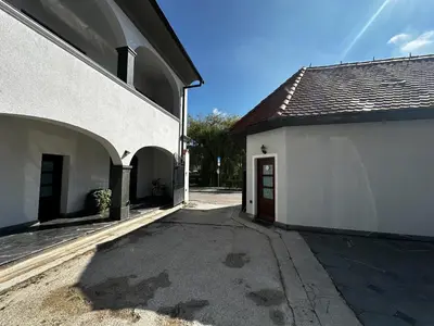 an alley between two white buildings with a red door at Eipprova deluxe apartment in Rove