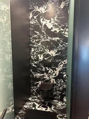 a bathroom with a black and white wall at Eipprova deluxe apartment in Rove