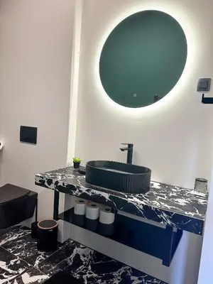 a bathroom with a sink and a mirror at Eipprova deluxe apartment in Rove
