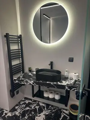 a bathroom with a sink and a mirror on a counter at Eipprova deluxe apartment in Rove