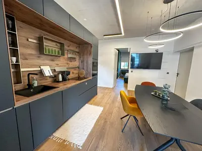 a kitchen with a table and yellow chairs in a room at Eipprova deluxe apartment in Rove